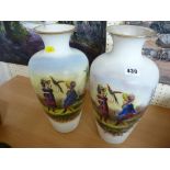 Pair of Continental milk glass vases with figures of children (rim damage to one)
