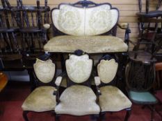 Circa 1900 carved mahogany salon suite of two seater settee and five (four plus one) side chairs
