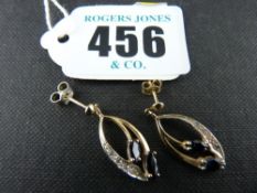 Pair of nine carat gold oval leaf shaped earrings with an outer band of czs and two oval cut dark