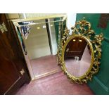 Ornate oval mirror and a square bevelled edge mirror with leaf decoration