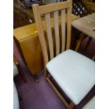 Light wood drop leaf table and four chairs with cream faux leather seats