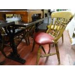 Hardwood table with metal supports and five spindlebacked chairs