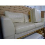 Ultra modern two seater cream leather effect lounge settee and matching footstool