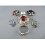 Four Scottish stone set brooches, a silver and lapis pendant and a Trafiri bangle, three brooches