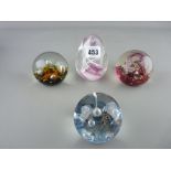 Four glass paperweights, two marked Caithness, one other Scottish maker