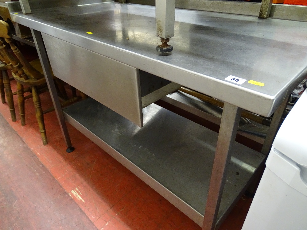 Stainless steel two tier catering table with central drawer, 123 x 66 cms