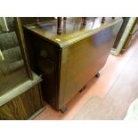 Twin flap gate leg table with interior drawer and storage cupboard