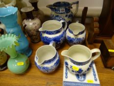 Five blue and white decorative jugs and a pair of Wedgwood blue and white square tiles with