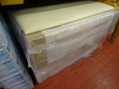 Unused 4ft 6ins double divan bed base (still packaged) with a cream leather effect headboard