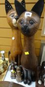 Two large carved wooden Siamese cats together with two small wooden carved mice
