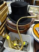 A vintage top hat in a leather box together with a brass ear trumpet