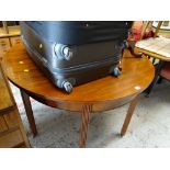 An antique circular mahogany dining table / a pair of D-end tables