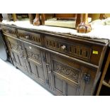 An antique reproduction carved sideboard
