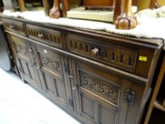 An antique reproduction carved sideboard