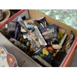 A box containing numerous collectable fridge magnets from various locations around the world