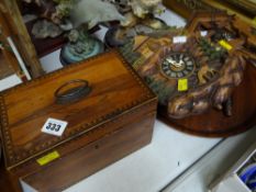 A believed walnut & inlaid tea caddy together with two tourist cuckoo clocks