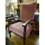 A vintage armchair in buttoned pink upholstery