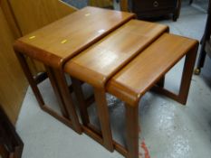 A mid-century nest of three coffee tables with curved supports