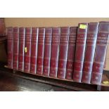 Thirteen volumes of The Children's Dictionary / Encyclopedia on stand