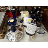 A collection of Wade Pusser's Rum ship's decanters, matching enamel drinking mugs, vintage bottles