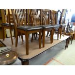 A large modern mahogany dining table & eight chairs by Julian Bowen