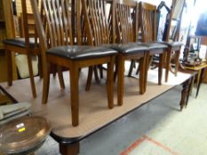 A large modern mahogany dining table & eight chairs by Julian Bowen