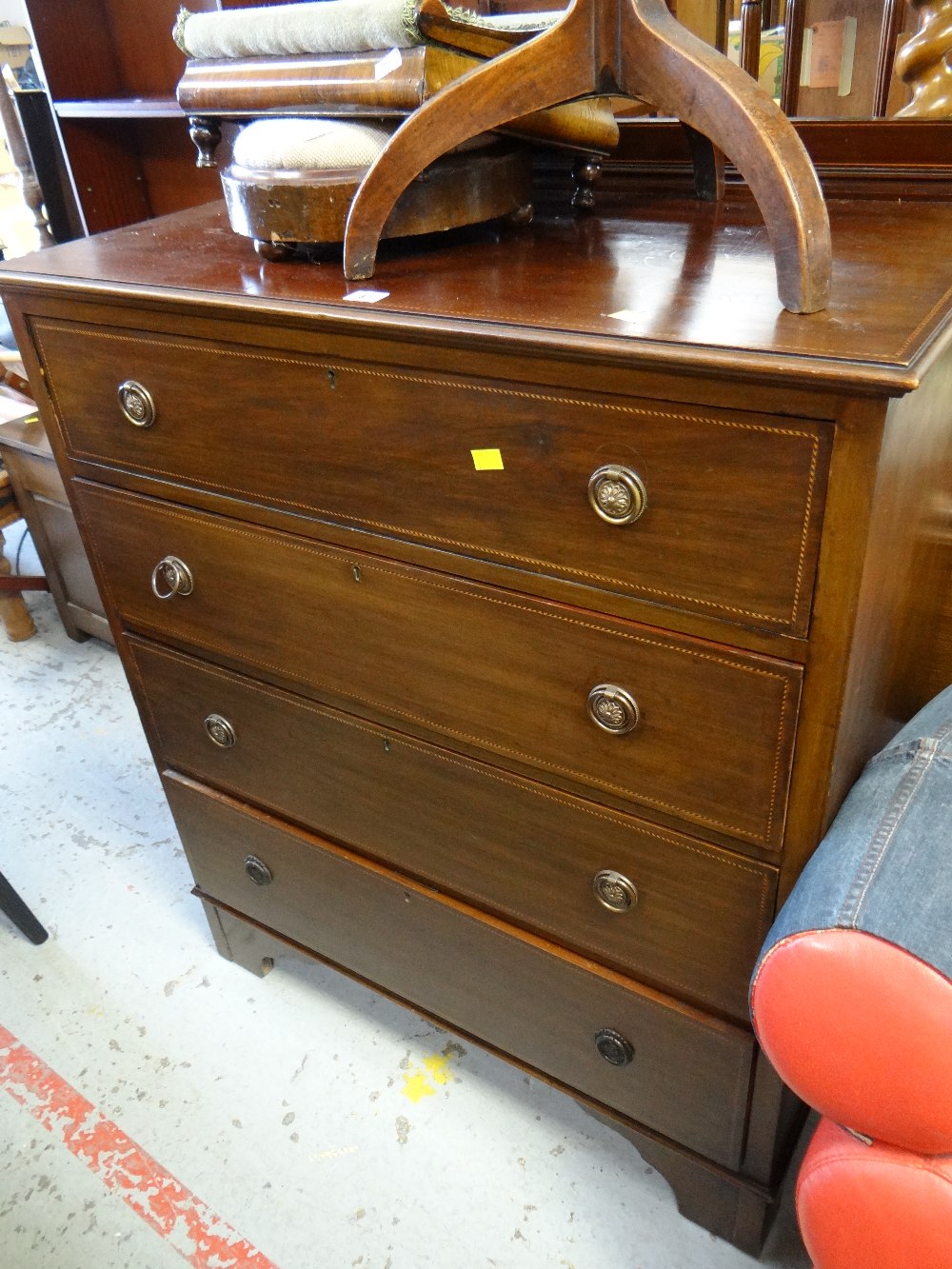 An Edwardian inlaid mahogany four-drawer railback chest