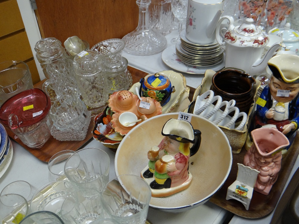 A tray of pottery items including Toby Jugs & a tray of crystal glass including a footed cranberry
