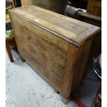 A vintage oak drop flap kitchen table