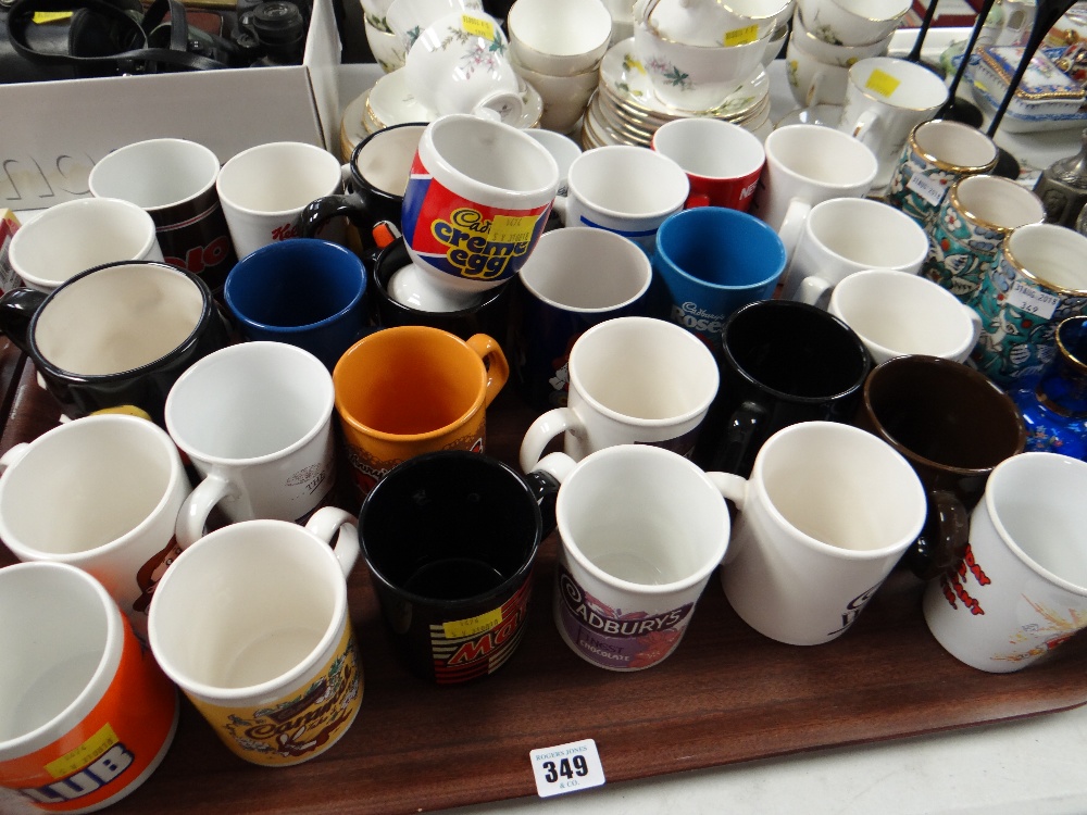 A tray of various special issue various Cadbury's chocolate coffee mugs