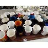 A tray of various special issue various Cadbury's chocolate coffee mugs