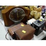 A vintage electric mantel clock together with a parcel of vintage cameras