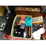 Crate containing two briefcases & a large selection of leather gloves, purses etc