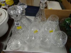A collection of crystal glass including three decanters, brandy bowls etc