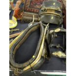 An antique leather & brass horse collar together with a decorated bridal by Perrott Brothers of