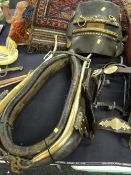 An antique leather & brass horse collar together with a decorated bridal by Perrott Brothers of