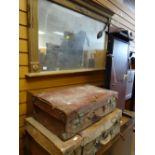 A modern gilt over mantel mirror & two vintage suitcases (distressed)