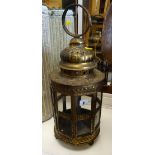 An antique brass & glass swinging lantern