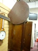 Vintage cricket table and a polished wood cabinet with twin doors and castors