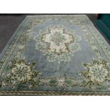 Large Chinese washed woollen rug with floral design and tasselled ends, 385 x 274 cms