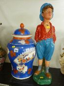 Oriental pottery lidded vase and a composite standing figure of a whistling boy