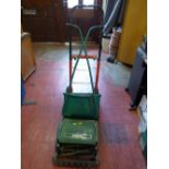 Manual Qualcast Panther 30S lawnmower and a red and black sack trolley