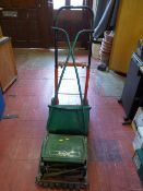 Manual Qualcast Panther 30S lawnmower and a red and black sack trolley