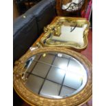 Oval gilt framed mirror with extending sconce and an ornate gilt framed mirror