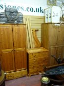 Suite of modern pine bedroom furniture including two wardrobes, chest of drawers and bed frame