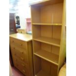 Modern light wood chest of five drawers and a slim four shelf bookcase