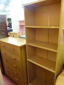 Modern light wood chest of five drawers and a slim four shelf bookcase