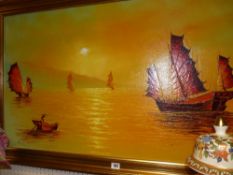 Oil on board - Oriental junks at sea under a setting sun, initialled 'N L A', 56 x 117 cms and a