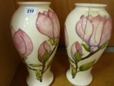 Pair of Moorcroft 'Magnolia' baluster vases, 31 cms high A/F
