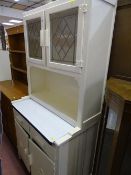 White painted kitchen dresser with enamel centre drawer shelf and two drawers and two cupboards